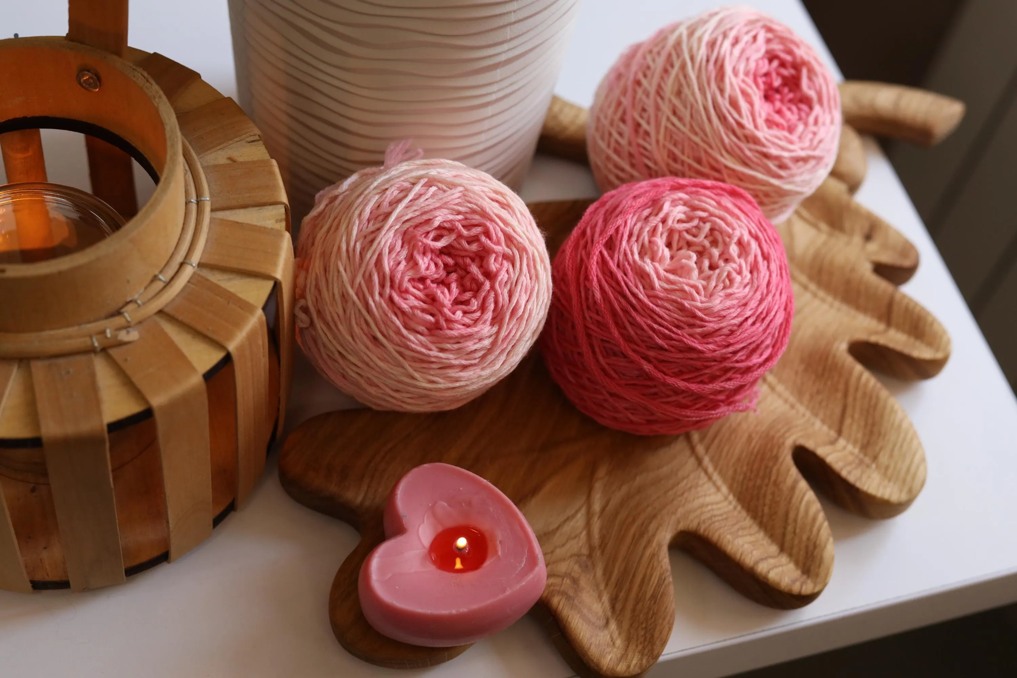 Hand dyed pink gradient merino wool yarn cakes in blush, rose, and soft pink shades, 100% merino wool DK weight yarn for knitting and crochet.