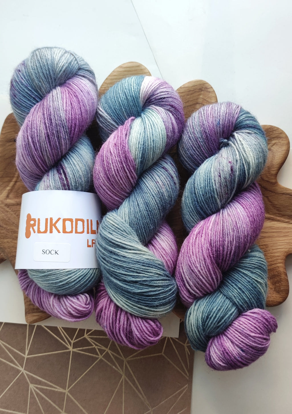Hand dyed sock yarn in soft lavender and sage tones, made from superwash merino wool and nylon, ideal for knitting socks, shawls, and everyday knitwear.