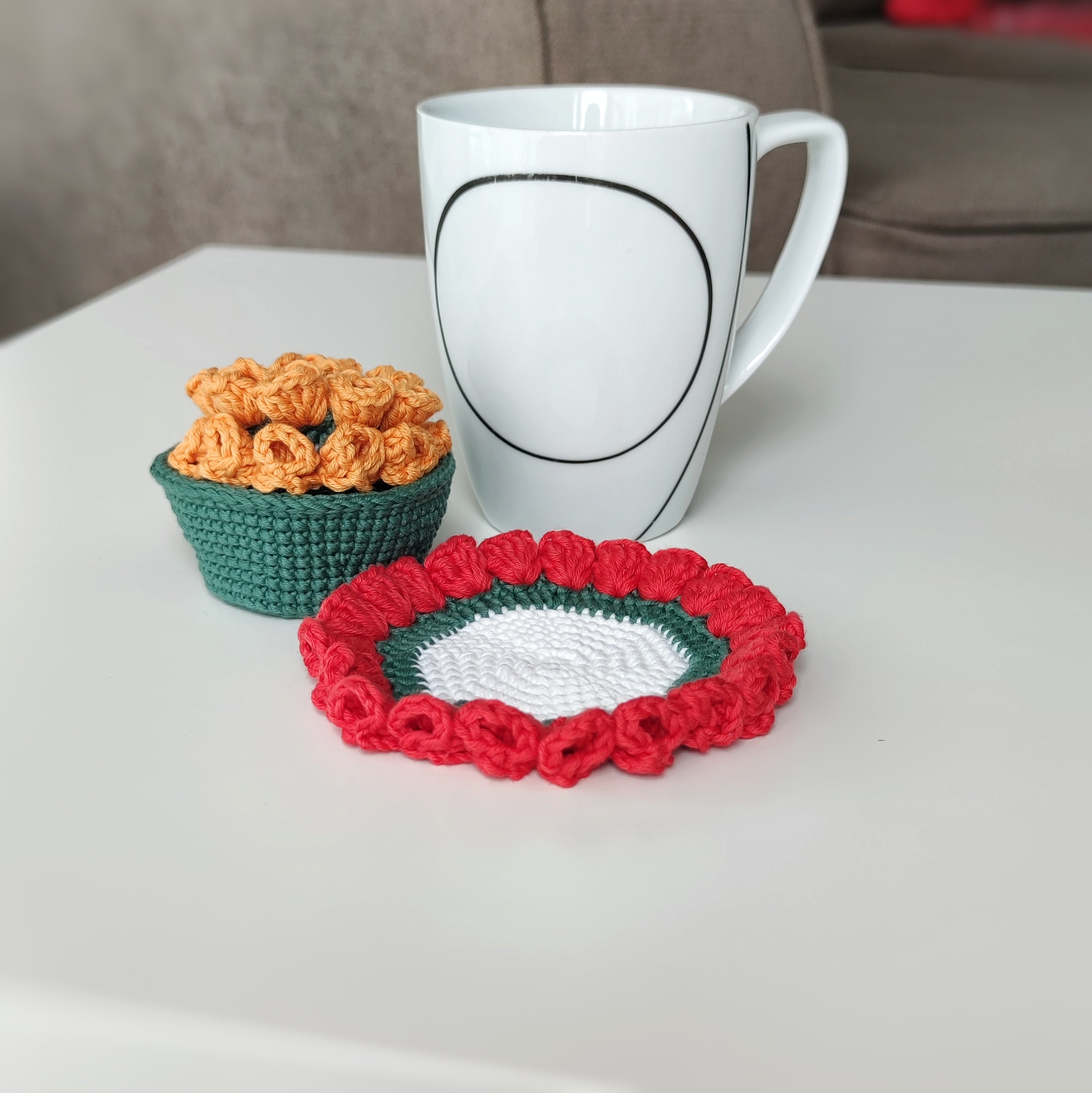Crochet flower coaster and small crochet basket with decorative petals, pattern example shown.