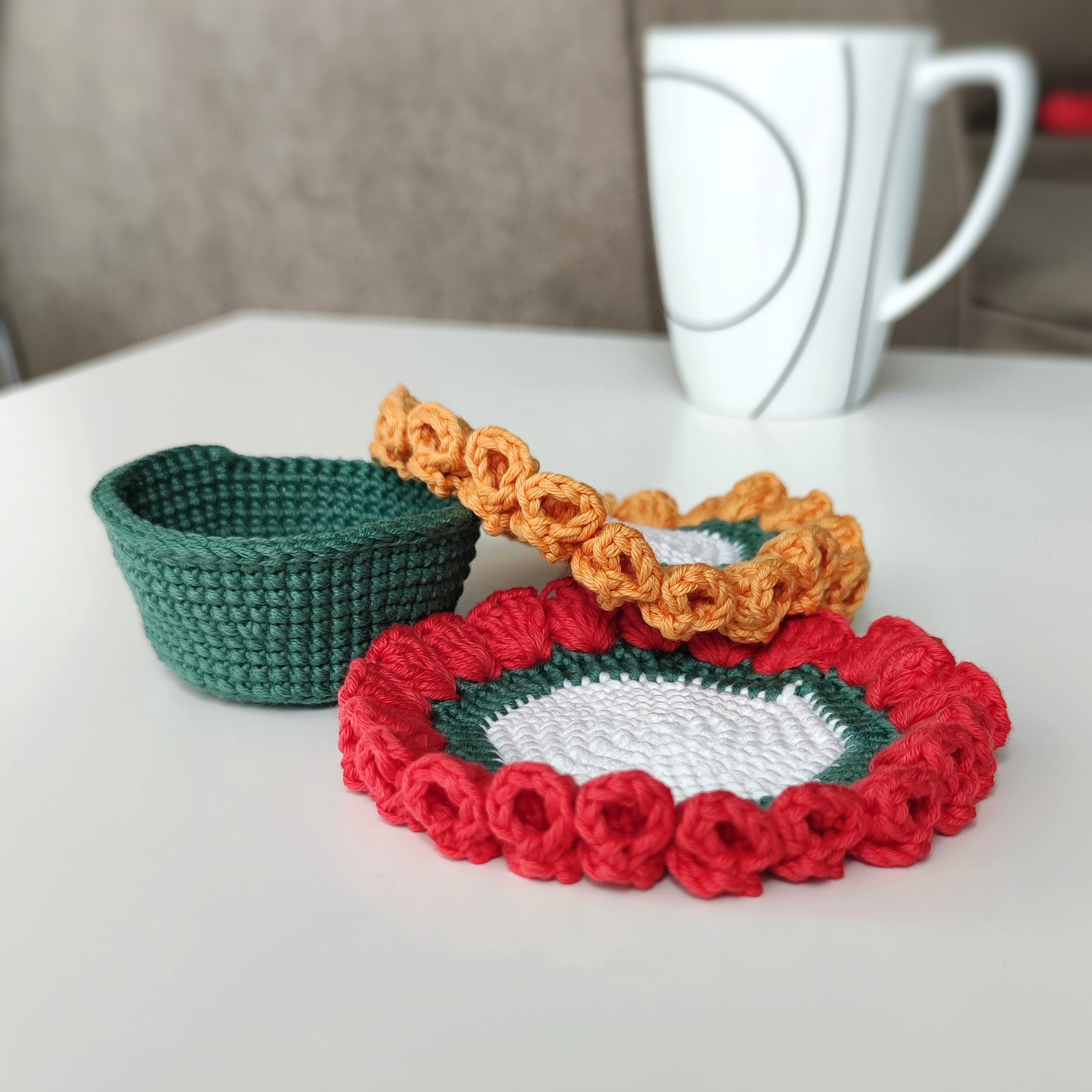 Crochet flower coaster and small crochet basket with decorative petals, pattern example shown.