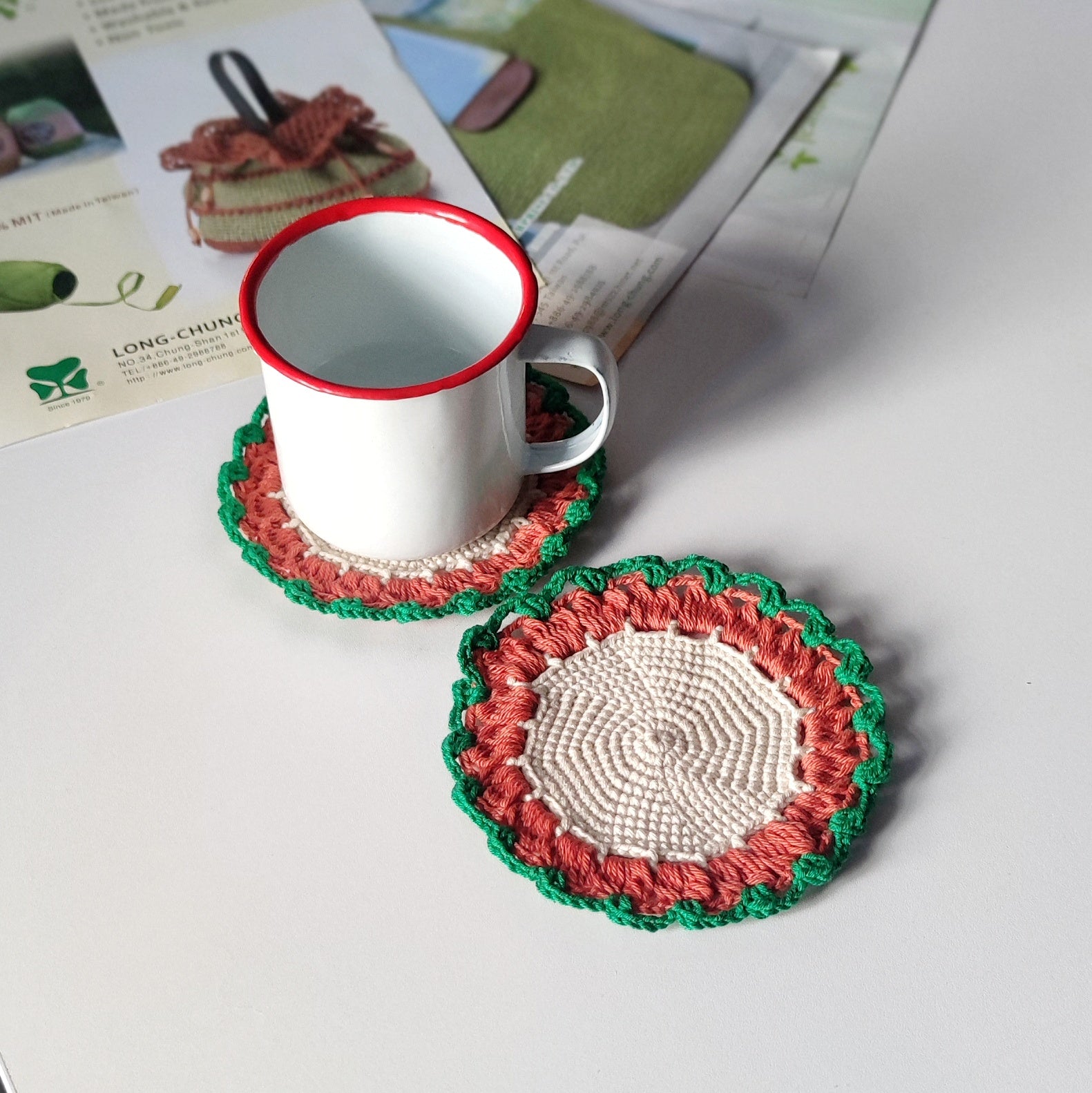 Beginner friendly crochet coaster used under a cup, simple round coaster pattern example shown.