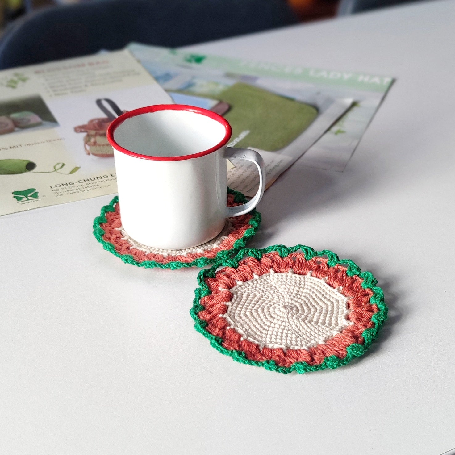Beginner friendly crochet coaster used under a cup, simple round coaster pattern example shown.