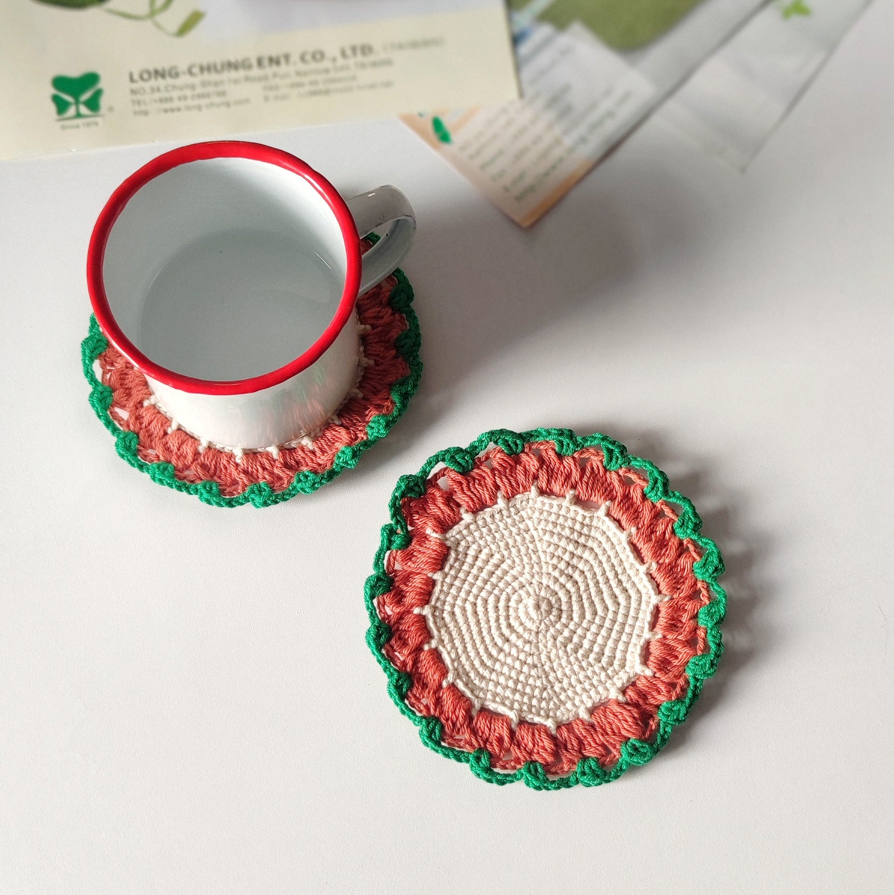 Beginner friendly crochet coaster used under a cup, simple round coaster pattern example shown.