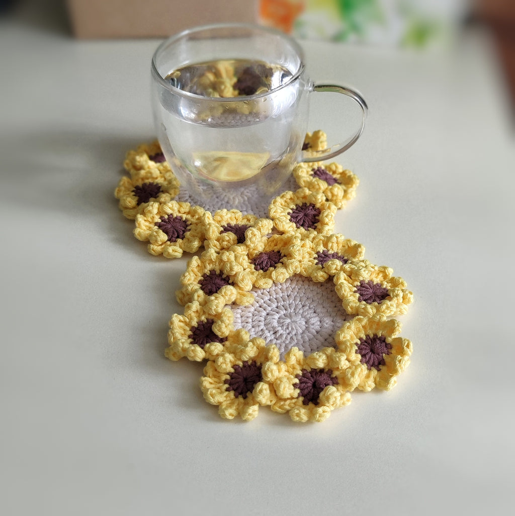 Sunflower crochet coasters with textured petal clusters, pattern example shown.