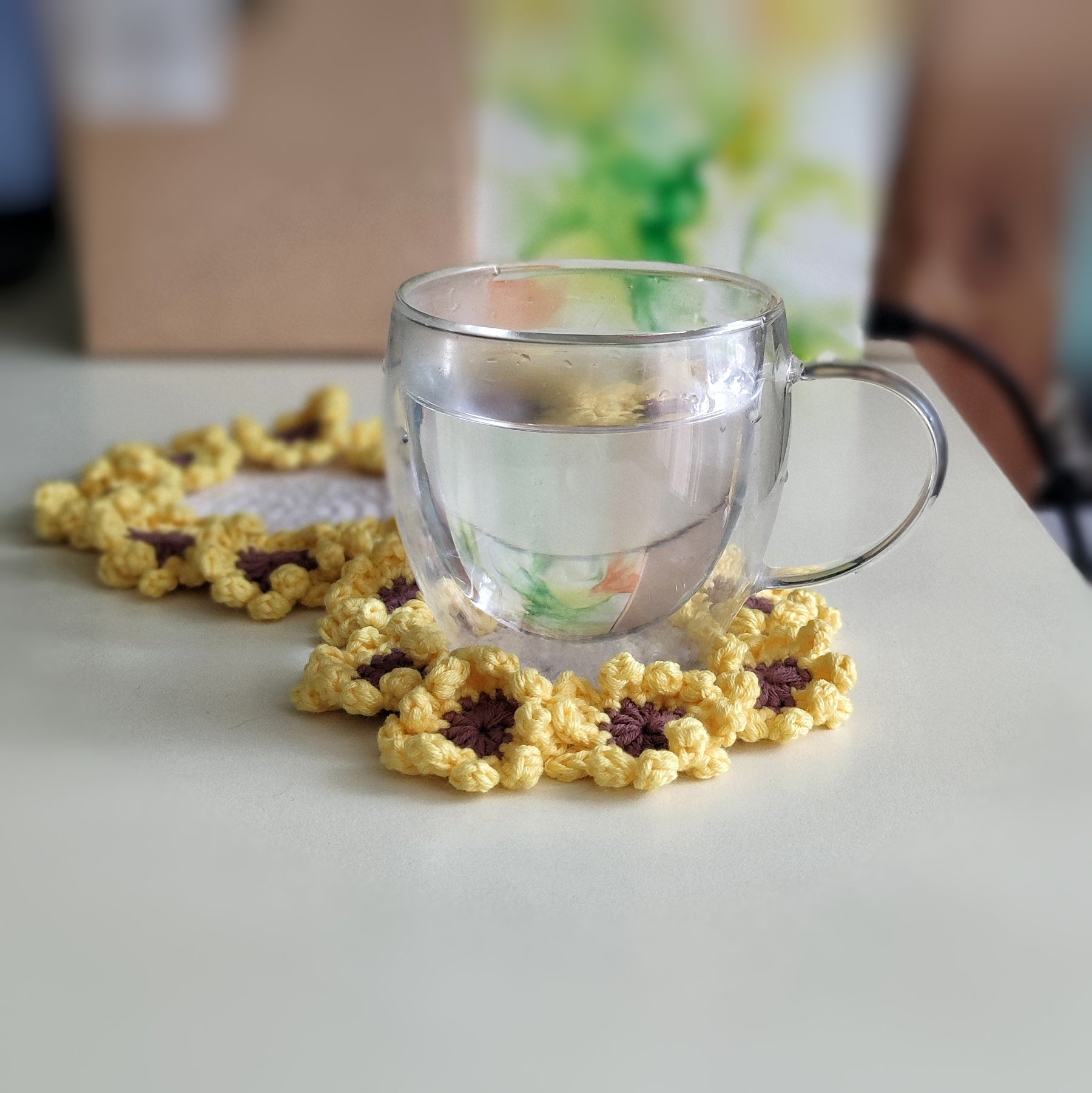 Sunflower crochet coasters with textured petal clusters, pattern example shown.