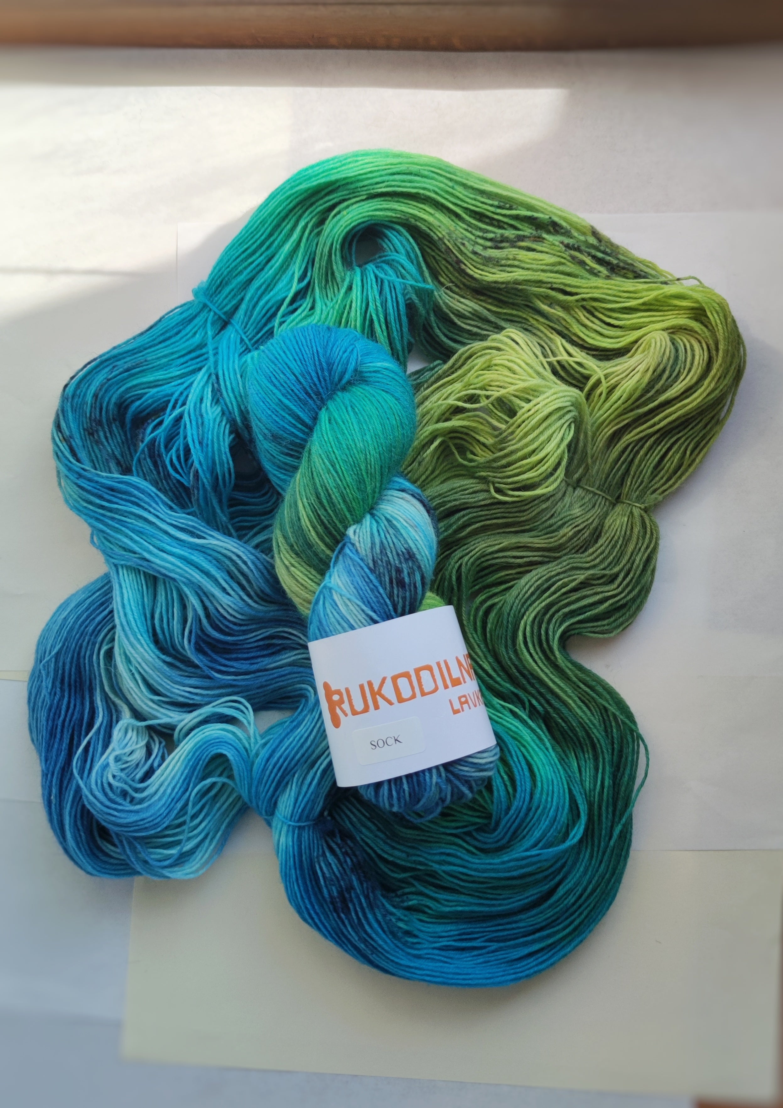 Hand dyed sock yarn in blue green tropical tones, variegated fingering weight wool nylon yarn for knitting socks