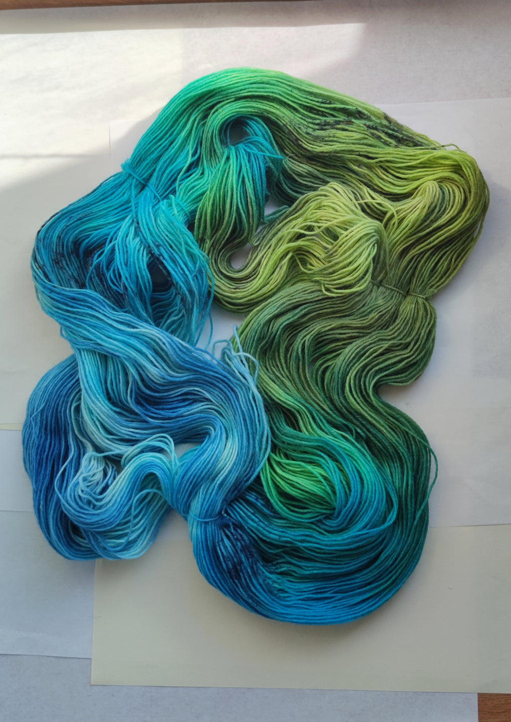 Hand dyed sock yarn in blue green tropical tones, variegated fingering weight wool nylon yarn for knitting socks