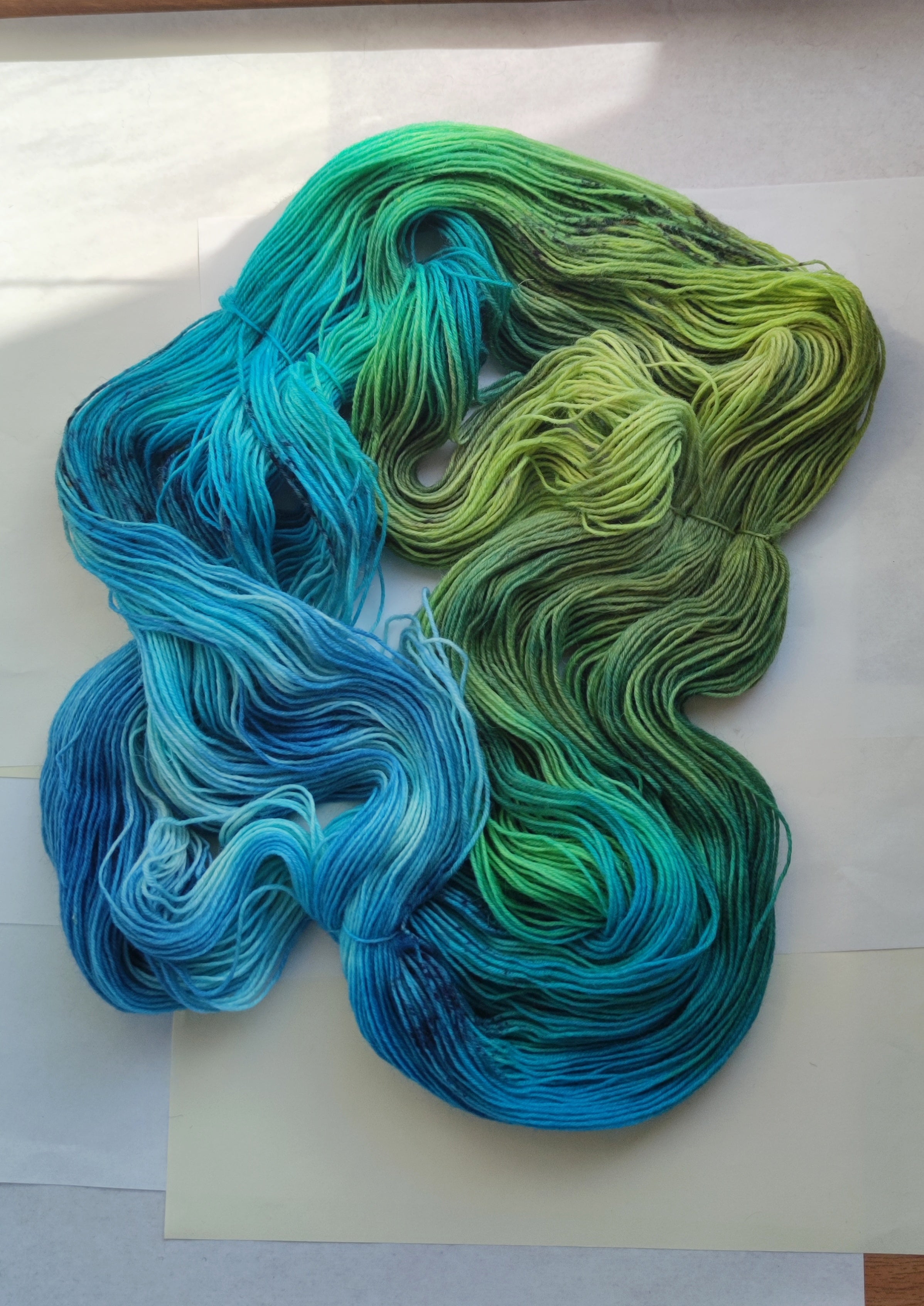 Hand dyed sock yarn in blue green tropical tones, variegated fingering weight wool nylon yarn for knitting socks