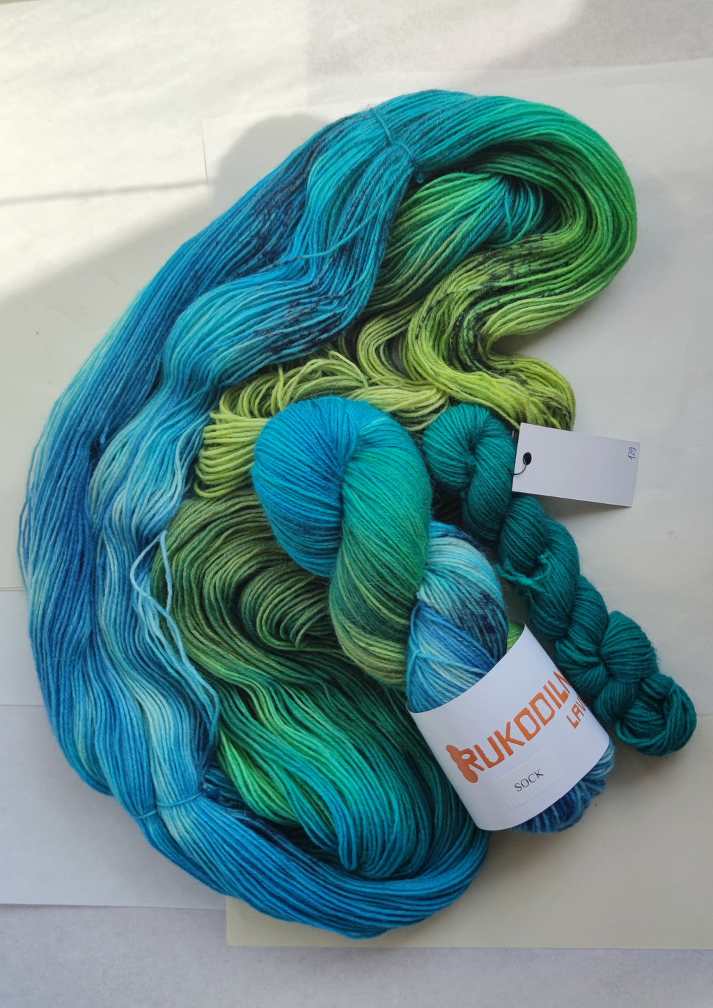 Hand dyed sock yarn in blue green tropical tones, variegated fingering weight wool nylon yarn for knitting socks