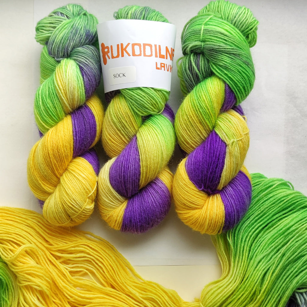 Hand dyed sock yarn skeins in purple, yellow and green variegated colors inspired by spring flowers