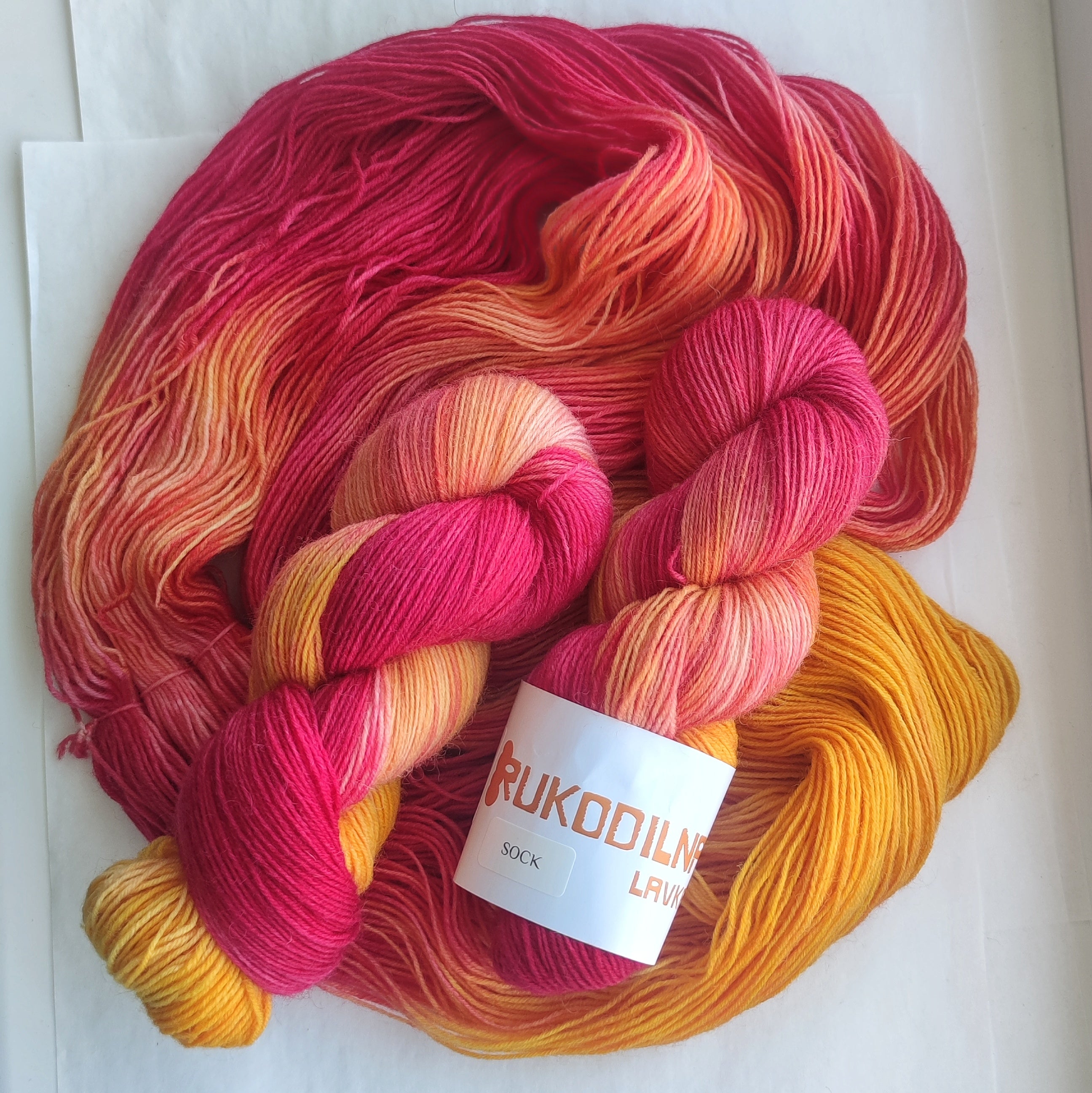 Hand dyed sock yarn set with hot pink, coral and bright orange full skein paired with two coordinating mini skeins for colorful sock knitting projects.