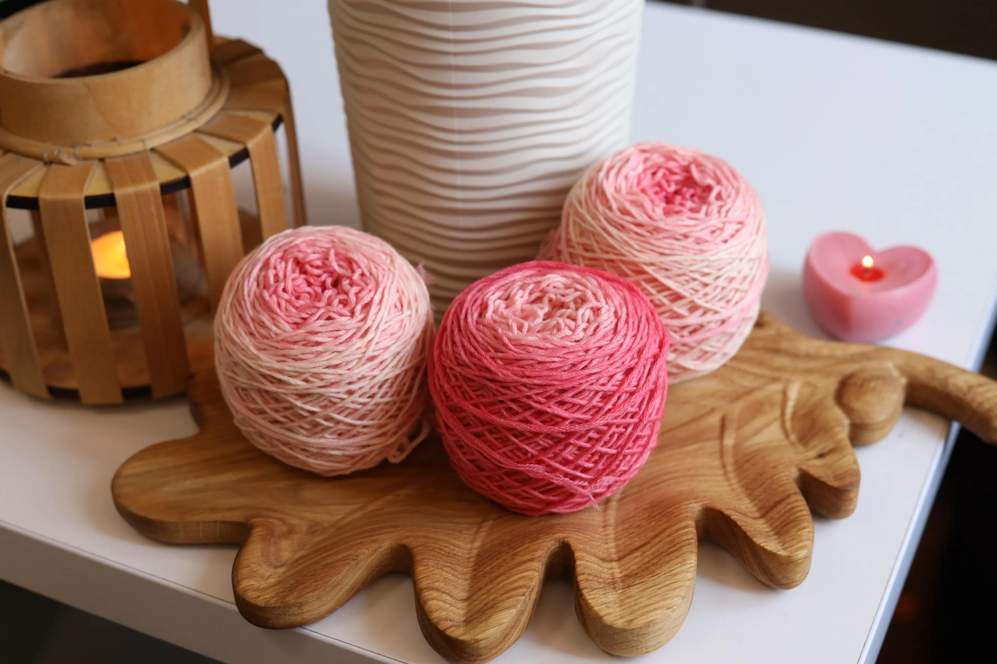 Hand dyed pink gradient merino wool yarn cakes in blush, rose, and soft pink shades, 100% merino wool DK weight yarn for knitting and crochet.