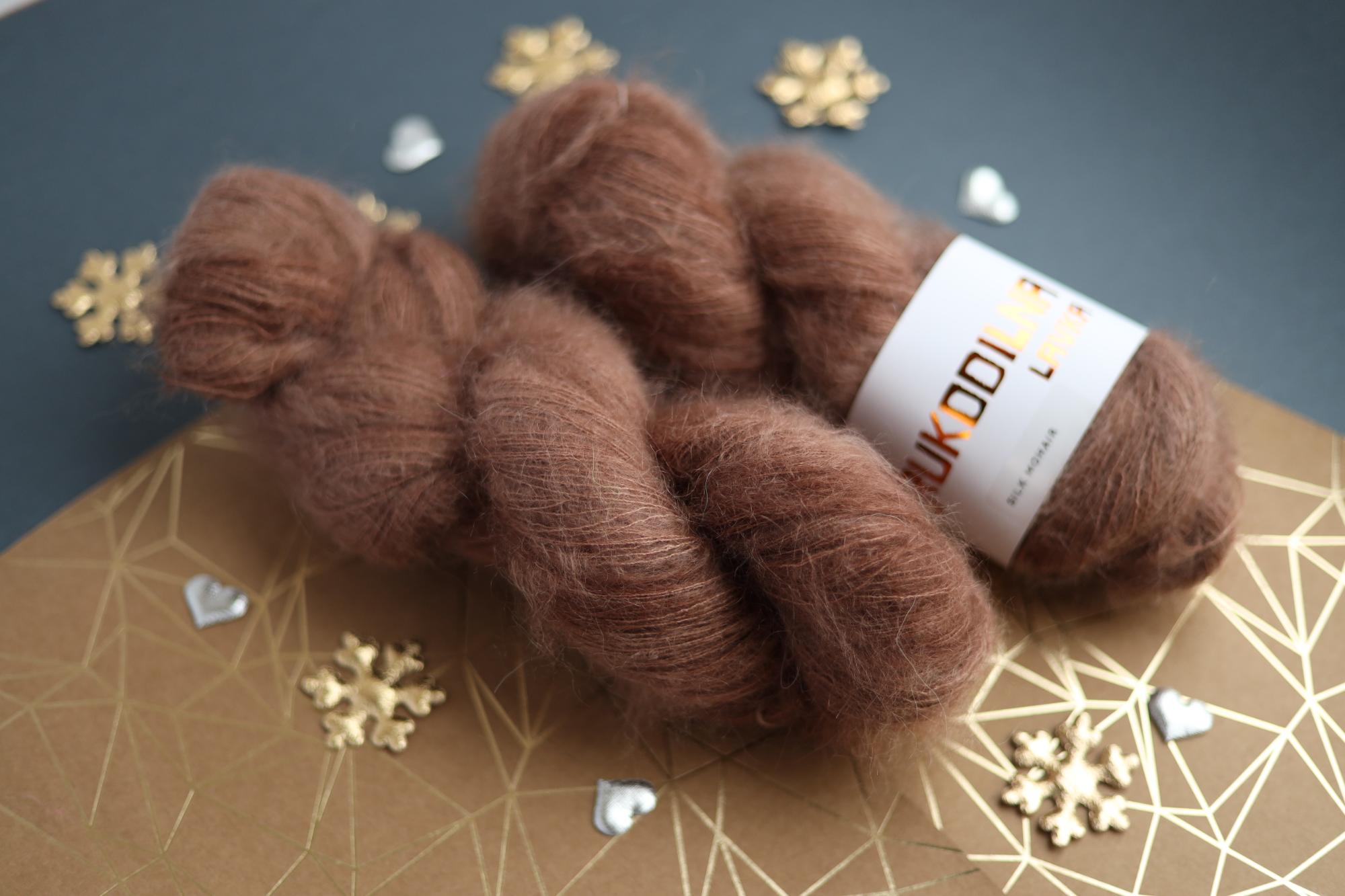 Three skeins of hand-dyed brown kid mohair silk yarn showing fluffy halo texture