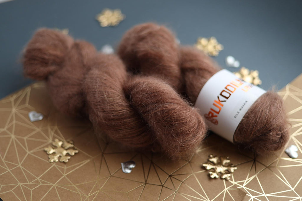 Three skeins of hand-dyed brown kid mohair silk yarn showing fluffy halo texture