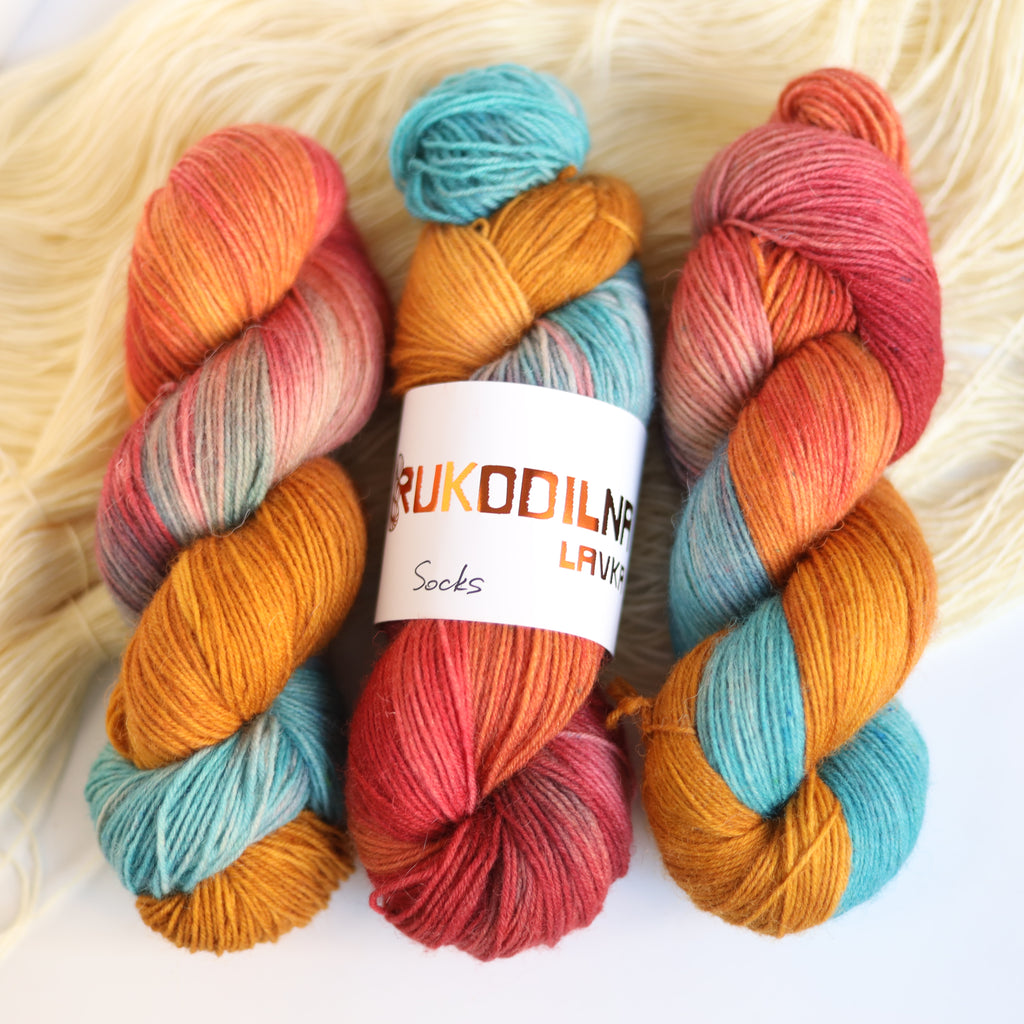 Hand dyed rust and teal sock yarn made from Italian superwash wool with knitted sock swatch, fingering weight 4-ply yarn dyed in Ukraine