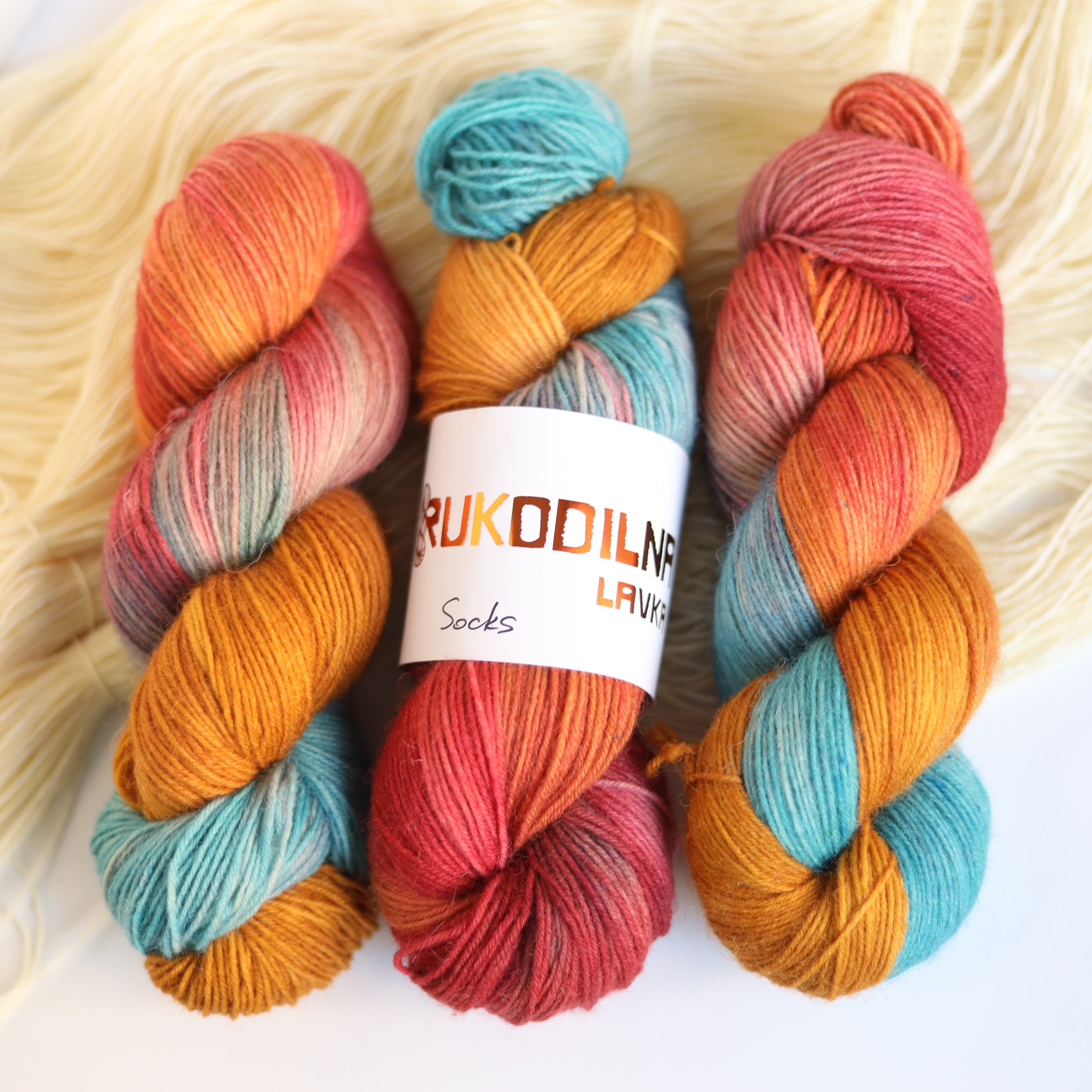 Hand dyed rust and teal sock yarn made from Italian superwash wool with knitted sock swatch, fingering weight 4-ply yarn dyed in Ukraine