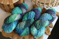 Blue green textured boucle yarn made from merino wool blend with fluffy loop texture for knitting and crochet