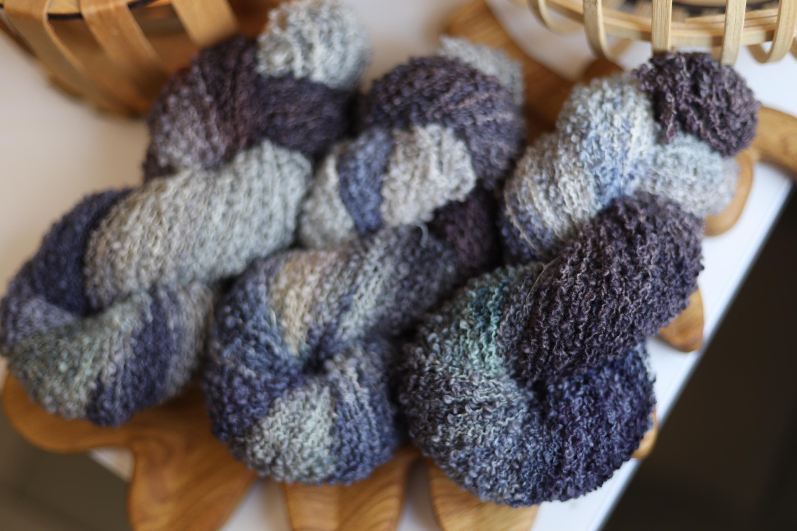 Smoky grey hand dyed boucle yarn made from merino wool blend with textured fluffy loop structure