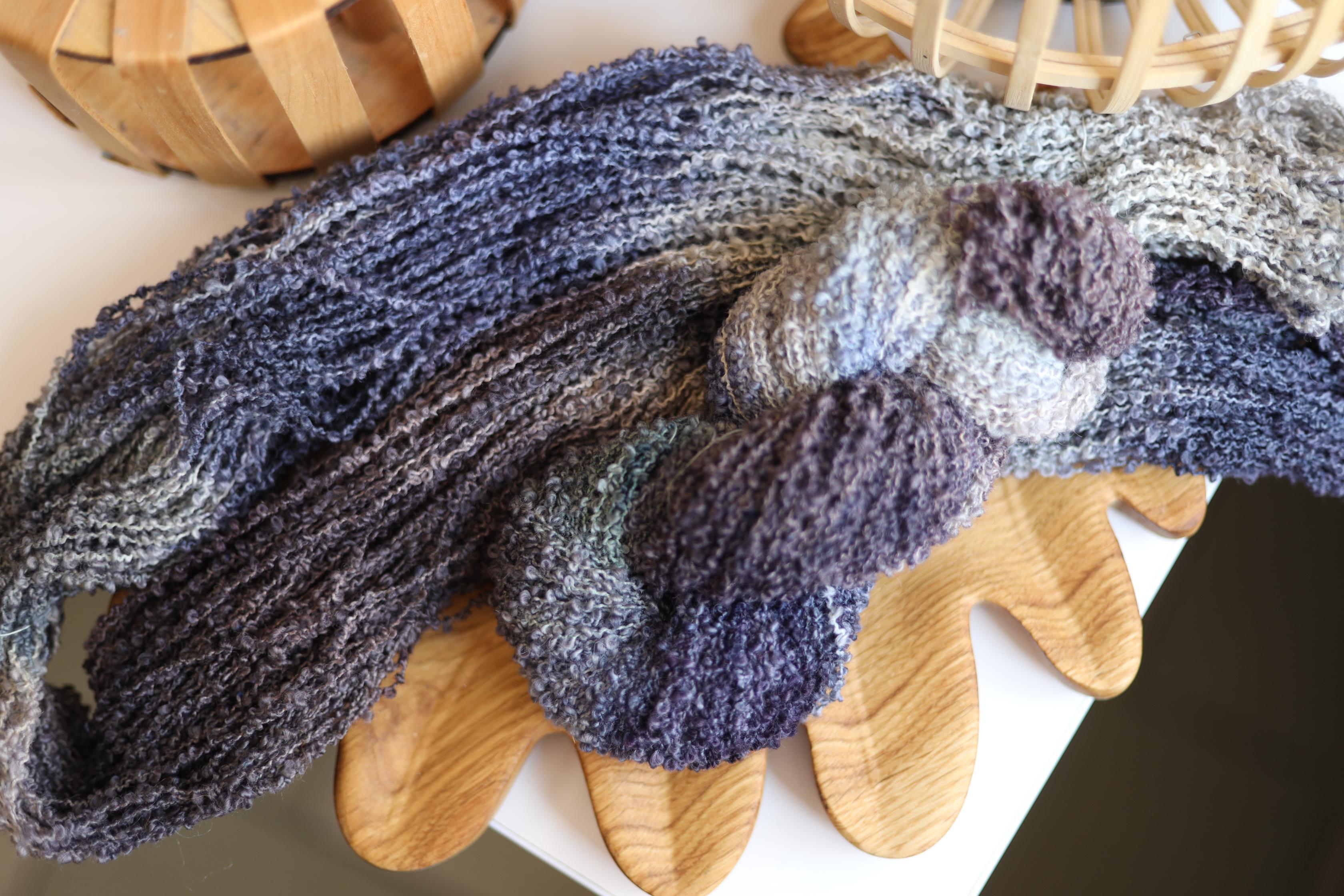 Smoky grey hand dyed boucle yarn made from merino wool blend with textured fluffy loop structure