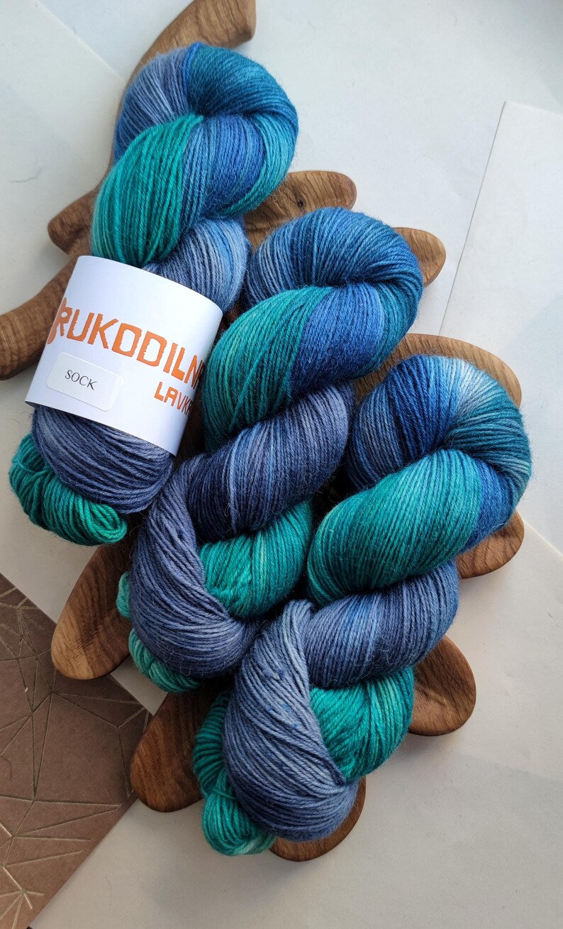 Hand dyed sock yarn in ocean blue, teal and smoky grey shades, superwash merino wool nylon fingering weight yarn for knitting socks, shawls and sweaters.
