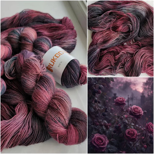 Hand-dyed sock yarn in blackberry, dusty rose and charcoal shades displayed as a variegated fingering weight wool nylon skein.