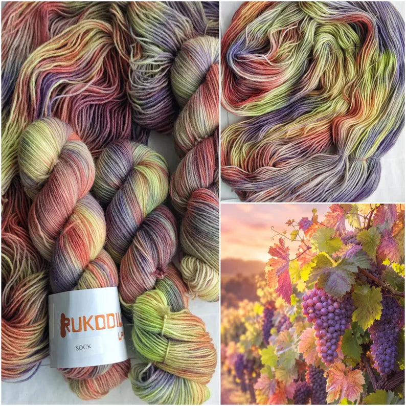 Hand dyed sock yarn in grape purple, lavender, blush pink, olive green and golden tones inspired by autumn vineyards.