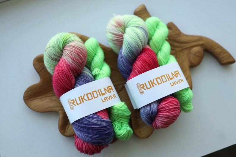 Hand dyed sock yarn set featuring vibrant purple, pink and lime green shades paired with a coordinating contrast mini skein. Perfect for colorful socks, shawls and accessories.