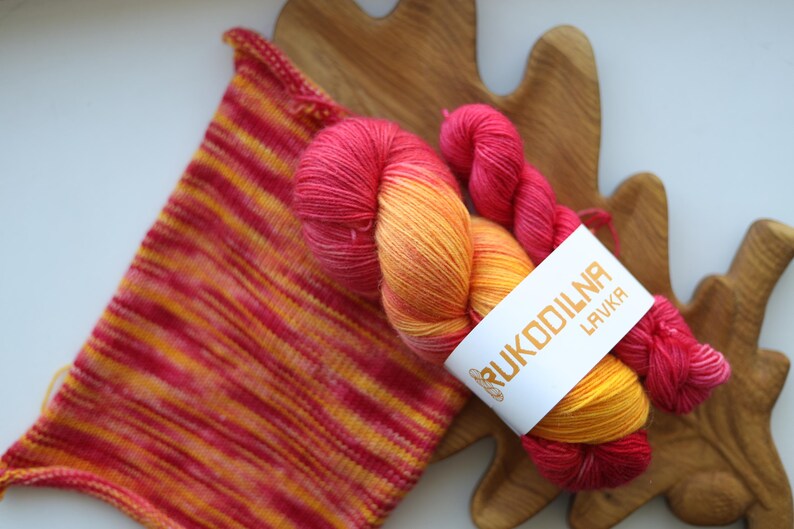 Hand-dyed sock yarn set with one 100g skein and one 20g mini in sunset shades of golden yellow, orange and raspberry red.