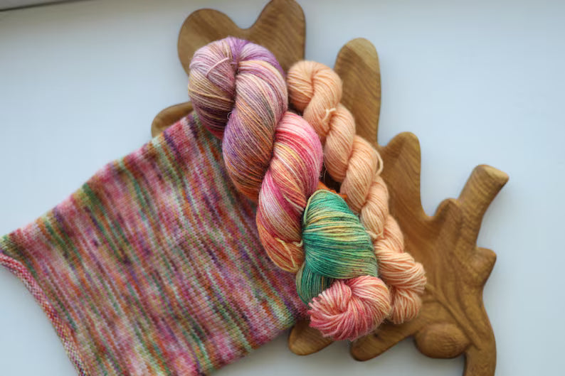 Hand-dyed variegated sock yarn set with one 100g skein and one matching mini skein in peach, blush pink, sage green and lavender colors.