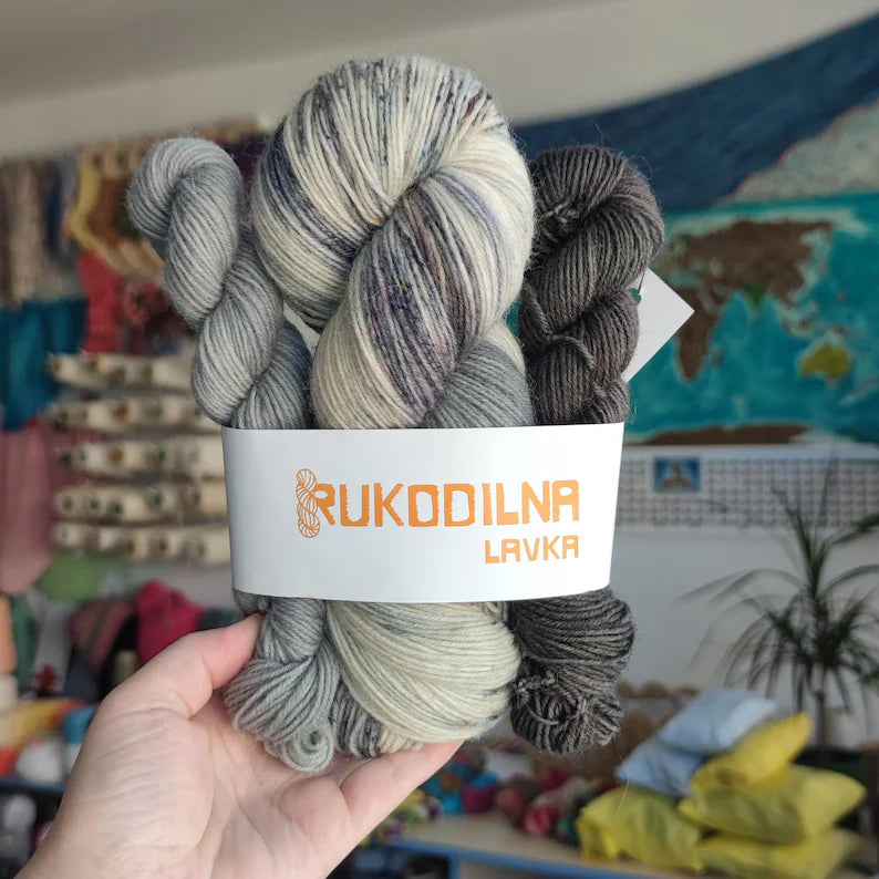 Hand dyed sock yarn set with full skein and two mini skeins in silver grey, charcoal and black shades, fingering weight wool nylon yarn for sock knitting projects.