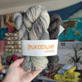 Hand dyed sock yarn set with full skein and two mini skeins in silver grey, charcoal and black shades, fingering weight wool nylon yarn for sock knitting projects.
