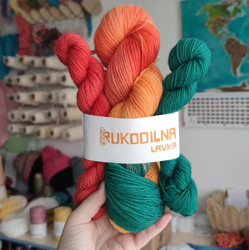 Hand dyed sock yarn set with one 100g skein and two 20g mini skeins in coral, peach and teal shades for knitting colorful socks.