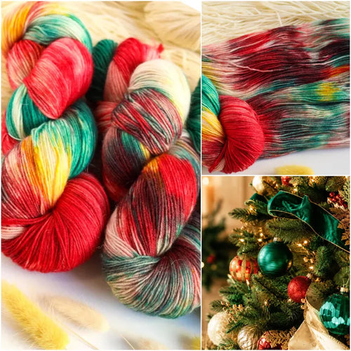 Christmas hand-dyed sock yarn in red, emerald green, golden yellow and ivory, variegated fingering weight superwash wool yarn for festive knitting.