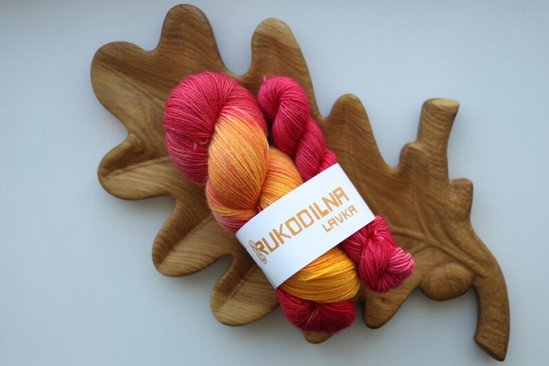Hand-dyed sock yarn set with one 100g skein and one 20g mini in sunset shades of golden yellow, orange and raspberry red.
