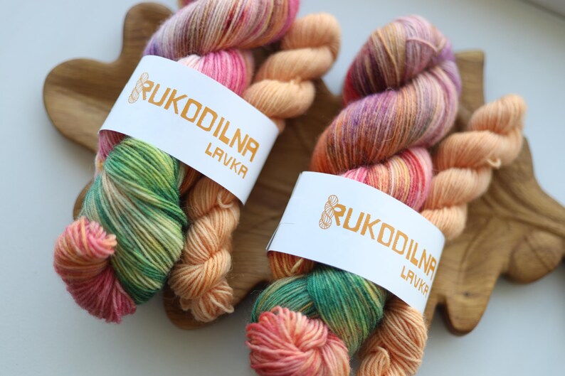 Hand-dyed variegated sock yarn set with one 100g skein and one matching mini skein in peach, blush pink, sage green and lavender colors.