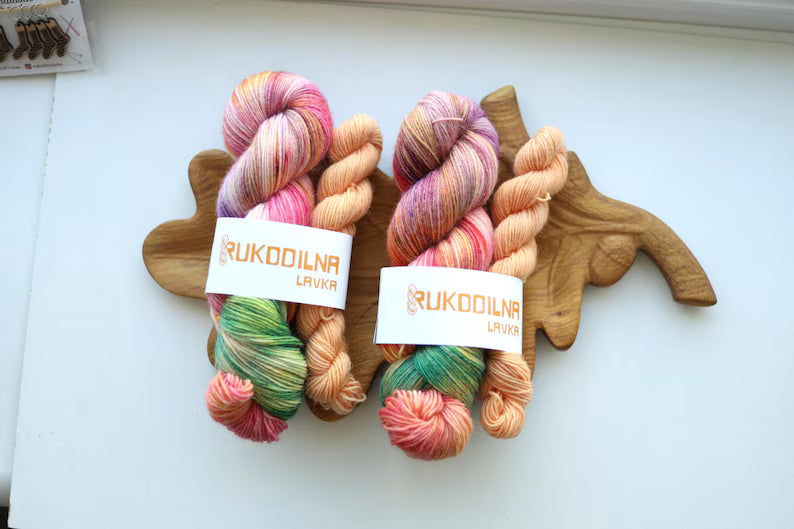 Hand-dyed variegated sock yarn set with one 100g skein and one matching mini skein in peach, blush pink, sage green and lavender colors.