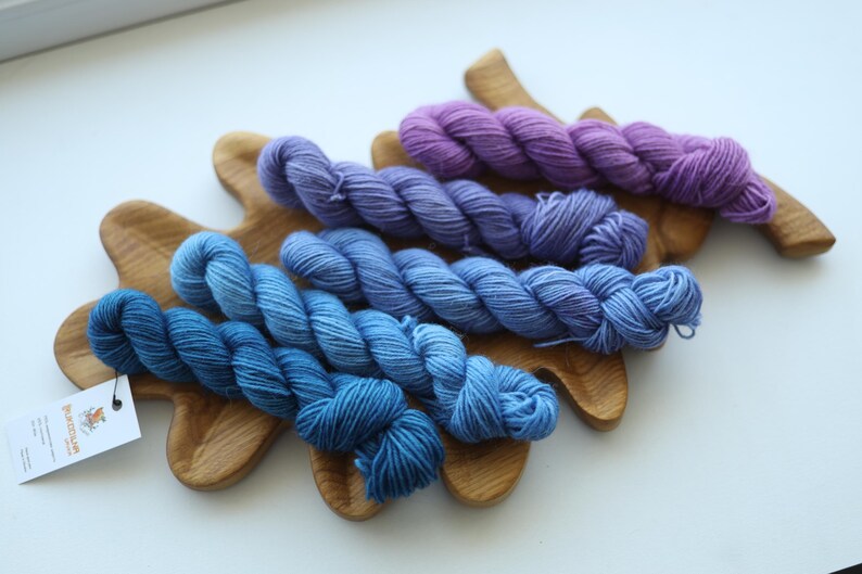 Hand dyed mini skein set with five blue and purple fingering weight sock yarn mini skeins for knitting and crochet colorwork.