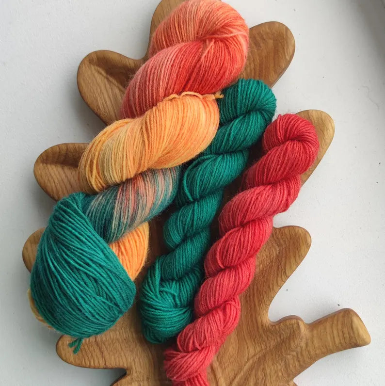 Hand dyed sock yarn set with one 100g skein and two 20g mini skeins in coral, peach and teal shades for knitting colorful socks.