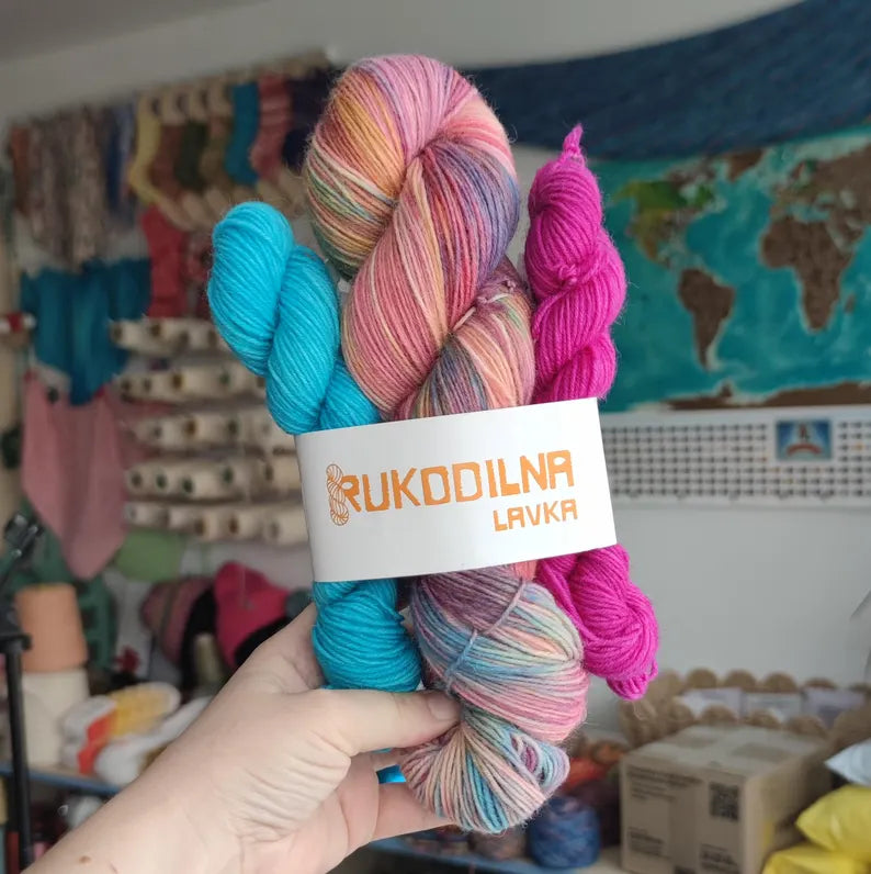 Hand-dyed sock yarn set with two mini skeins in turquoise and fuchsia, pastel pink, peach, lavender, and mint fingering weight wool nylon yarn for knitting colorful socks.