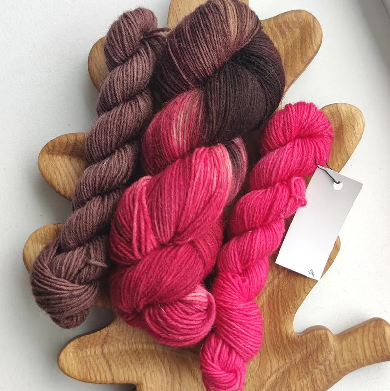 Hand dyed sock yarn set with one 100g skein and two 20g mini skeins in raspberry, chocolate brown and pink shades, fingering weight knitting yarn.