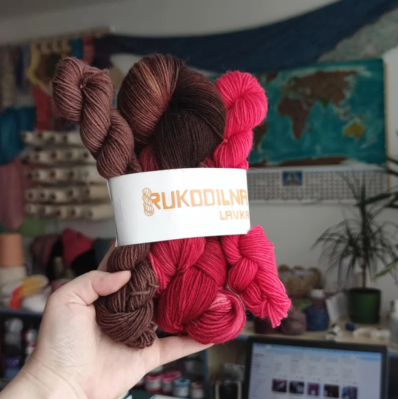 Hand dyed sock yarn set with one 100g skein and two 20g mini skeins in raspberry, chocolate brown and pink shades, fingering weight knitting yarn.