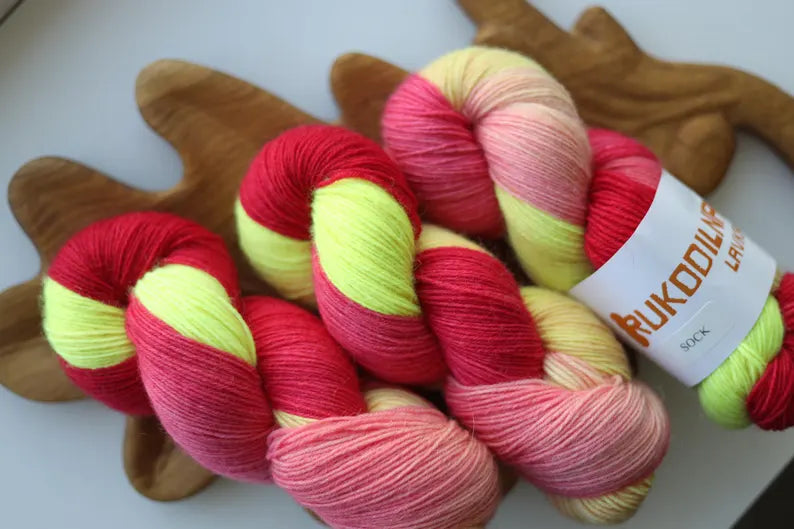 Hand-dyed fingering weight sock yarn in pink, coral, neon yellow and blush shades, 100g 400m, 75% wool and 25% polyamide.