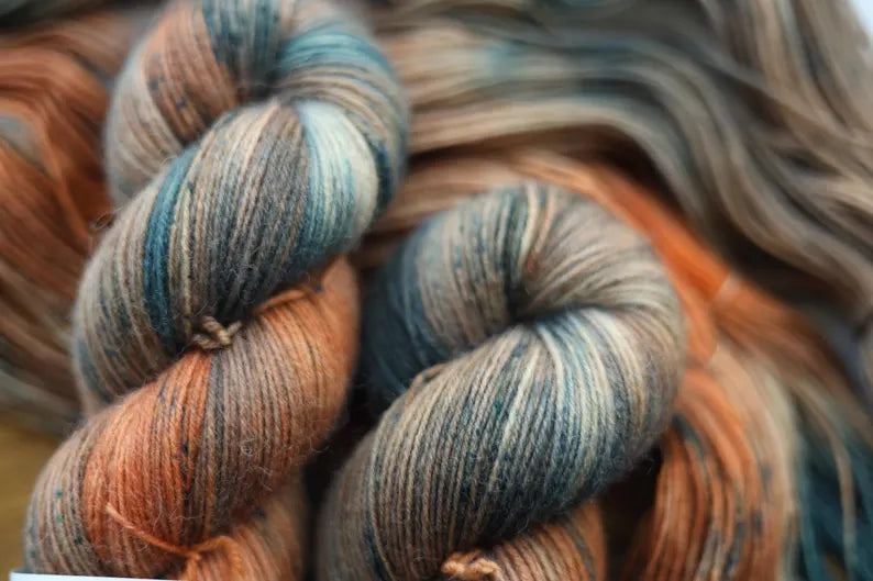 Hand-dyed autumn variegated sock yarn in teal, copper and earthy tones. Fingering weight, 75% wool, 25% polyamide, 100g / 400m. Perfect for socks, shawls and accessories