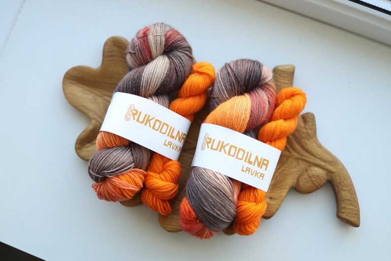 Hand dyed fall sock yarn set with a variegated taupe and rust skein paired with a bright pumpkin orange mini skein for knitting socks.
