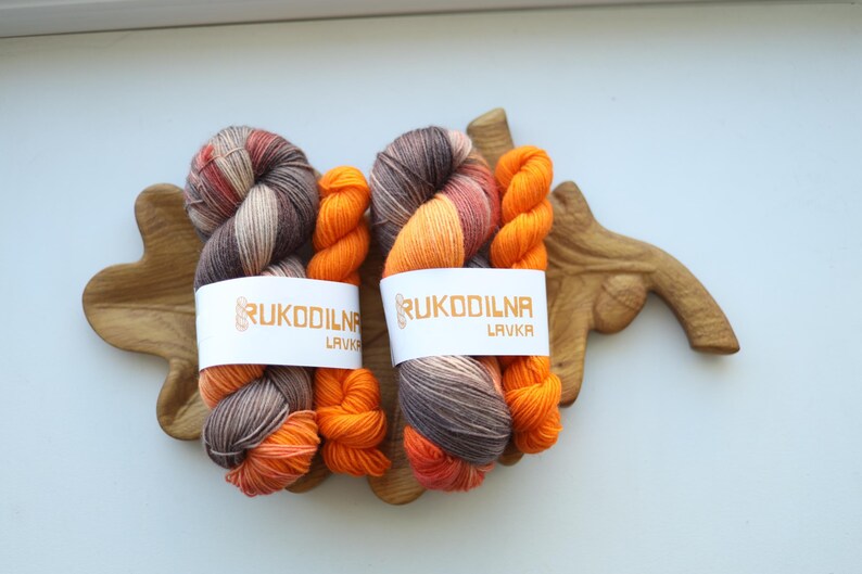 Hand dyed fall sock yarn set with a variegated taupe and rust skein paired with a bright pumpkin orange mini skein for knitting socks.