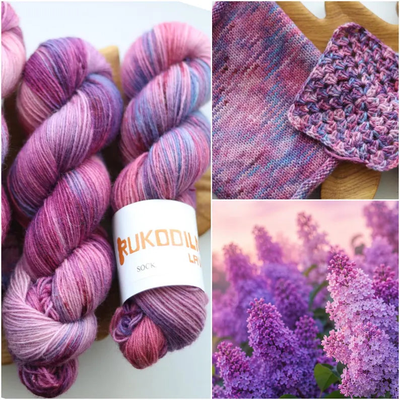Hand dyed lilac sock yarn in soft purple, blush pink and lavender with delicate blue speckles, fingering weight wool nylon knitting yarn.
