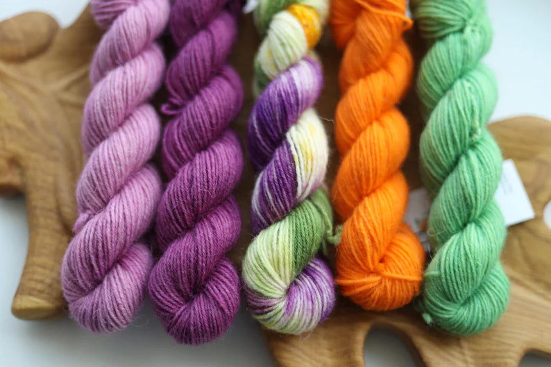 Bright hand dyed mini skein set in purple lavender orange green and multicolor fingering weight sock yarn
