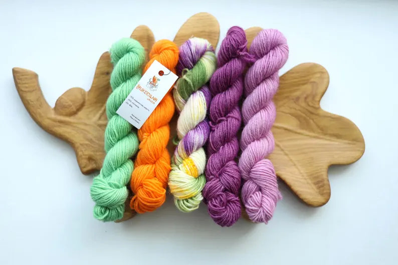 Bright hand dyed mini skein set in purple lavender orange green and multicolor fingering weight sock yarn