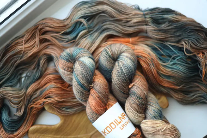 Hand-dyed autumn variegated sock yarn in teal, copper and earthy tones. Fingering weight, 75% wool, 25% polyamide, 100g / 400m. Perfect for socks, shawls and accessories