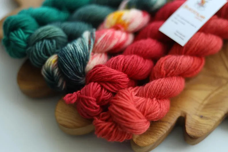 Christmas mini skein set with five hand dyed red green and multicolor fingering weight sock yarn minis